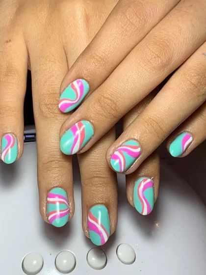 A playful design with a turquoise base and wavy pink and white stripes.