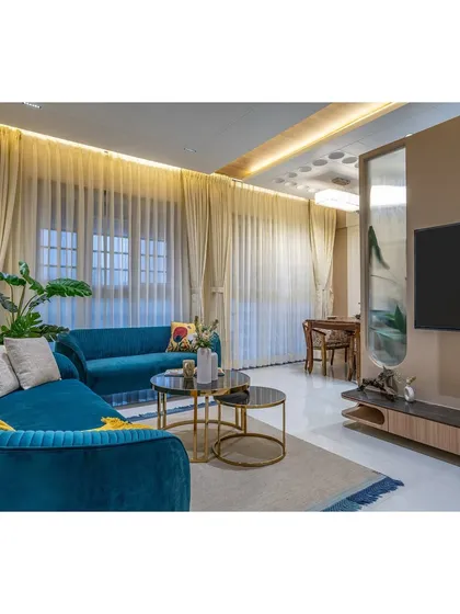 This view connects the living room to the dining area in the background, showing how we maintain a cohesive design language across different functional zones.