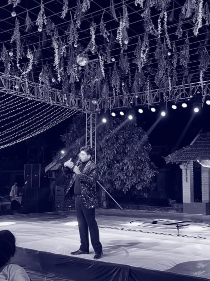 A powerful black and white shot of me alone on a large, beautifully decorated stage. This image captures the quiet moments of focus before I step into the spotlight to command the crowd.