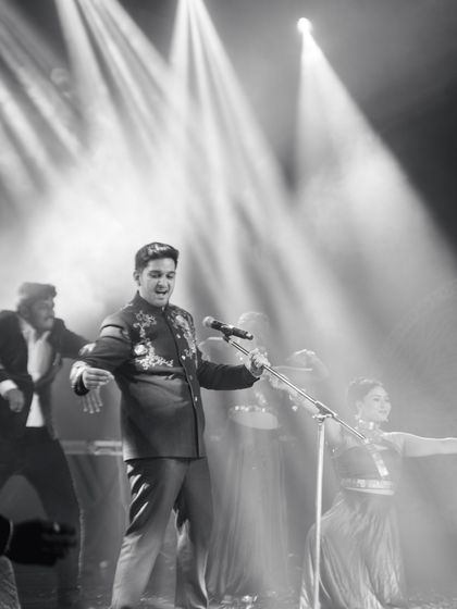 The groom channeling his inner rockstar. We love creating solo performances that let the groom's personality shine, complete with a mic, spotlights, and a whole lot of confidence.