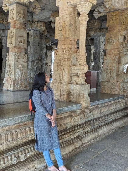 A duplicate image of me observing the intricate details of the temple pillars. These travels are an essential part of my artistic practice.