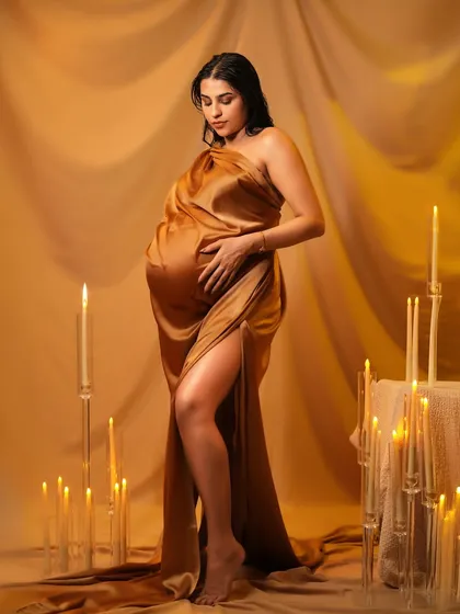 A full-length view of Pria's golden goddess look, showing the power and beauty of motherhood.