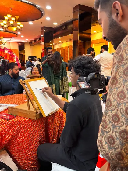 Here I am in my element, focused on sketching a guest at a lively wedding reception. My setup is professional and compact, designed to fit into any event space seamlessly.