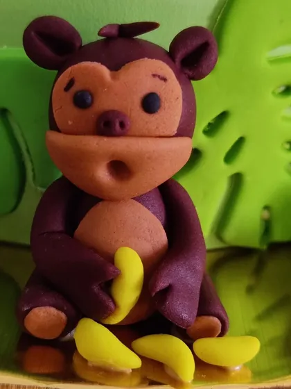 Look at this little fondant monkey, complete with his bunch of bananas. It's these small, playful details that make a custom cake so special and bring a smile to everyone's face.