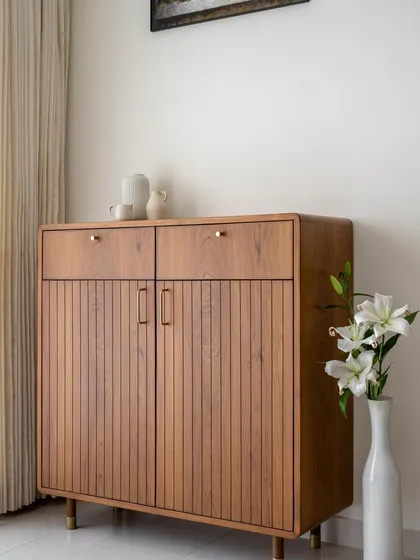 A freestanding crockery unit with fluted wooden doors, rounded corners, and brass-tipped legs from our 'Marshall' collection.