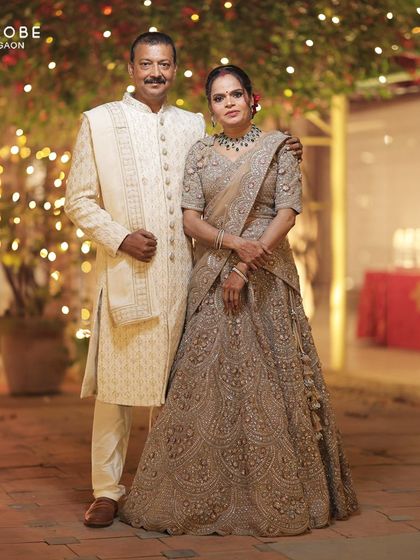 Another shot of the proud parents, dressed in a classic off-white sherwani and a detailed lehenga. I help the whole family look their best.