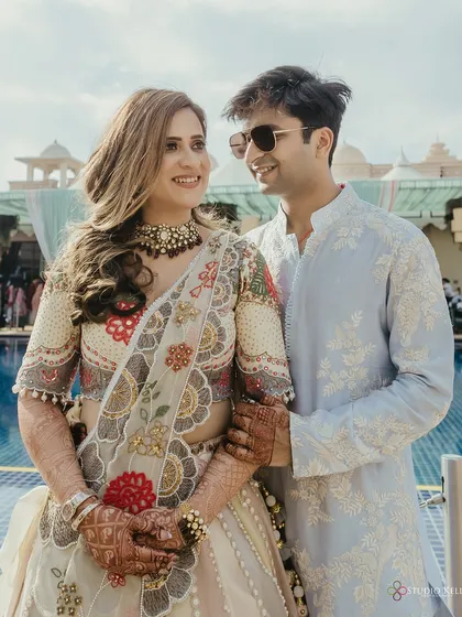 A happy portrait of the couple by the poolside at the ITC Grand Bharat.