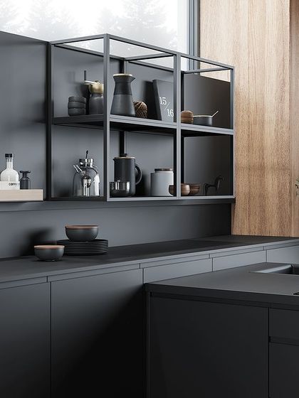 Open shelving in black metal adds an industrial touch to this all-black kitchen, providing a stylish space for a coffee station or display.