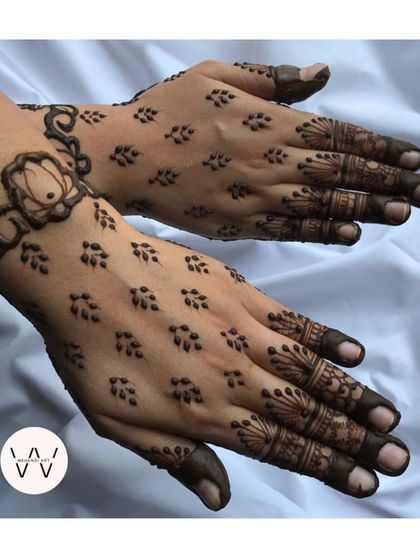 A minimalist design with a lotus bracelet and delicate leafy patterns on the back of the hand.