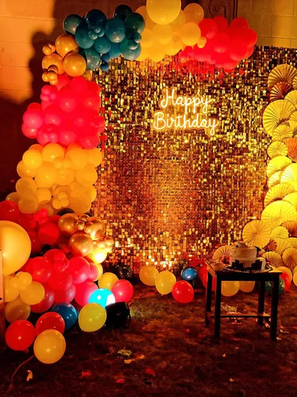 I love creating a magical vibe, and this Winnie the Pooh party setup did just that. The shimmering gold sequin wall, paired with a colorful balloon arch and a warm neon "Happy Birthday" sign, created a stunning focal point for the celebration.