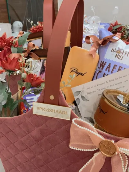 A close up of our custom bridesmaid hamper, showing the personalized hashtag plate, name tag, and a wax-sealed bow, because every detail matters when thanking your tribe.