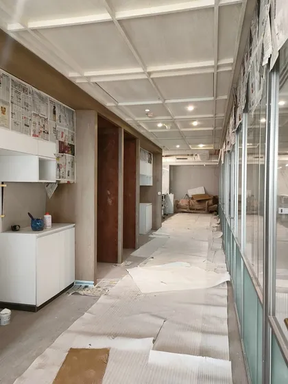 Another work-in-progress shot from Hamdard HQ, showing the installation of cabinetry and wall finishes. The space is protected as different trades work to bring the design to life.