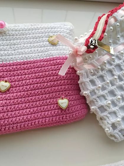 A couple of my custom pouches, showing the different styles I can create. The one on the right is the pearl pouch, and the one on the left is the pink and white heart charm pouch.