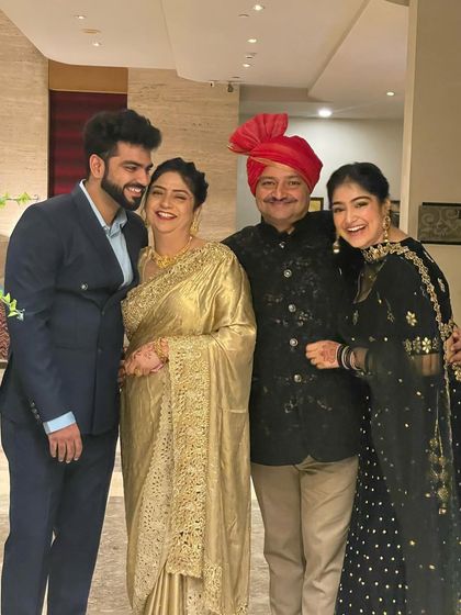 A happy family portrait is priceless. I helped style my family for our event, coordinating my dad's bandhgala, my mom's golden saree, and my brother's suit for a cohesive and elegant look.