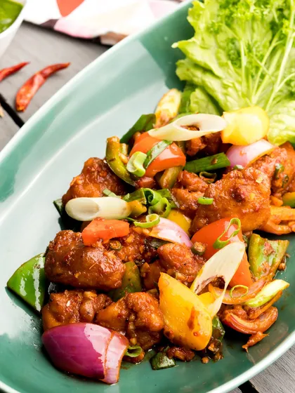 Sizzling and spicy Chilli Chicken, tossed with colourful bell peppers and onions. A classic Indo-Chinese appetizer that's always a hit.