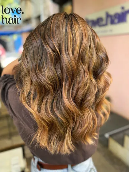 The back view shows the intense warmth and dimension of this bronde balayage.