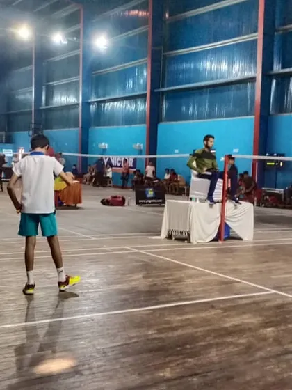 Two young players prepare for their match during a tournament. I ensure that every event, big or small, has the organized feel of a professional competition, right down to the on-court setup.