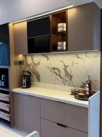 This angle shows the kitchen's smart storage solutions, including a pull-out pantry and integrated oven unit. We design every kitchen to be as practical as it is beautiful.