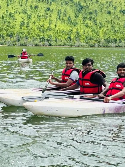 Participants in sit-on-top kayaks take a break on the water, enjoying the calm and scenic environment.
