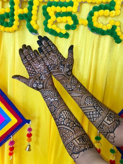 Another angle of the festive traditional mehandi, showing the flow and symmetry of the patterns from the fingers to the elbows.