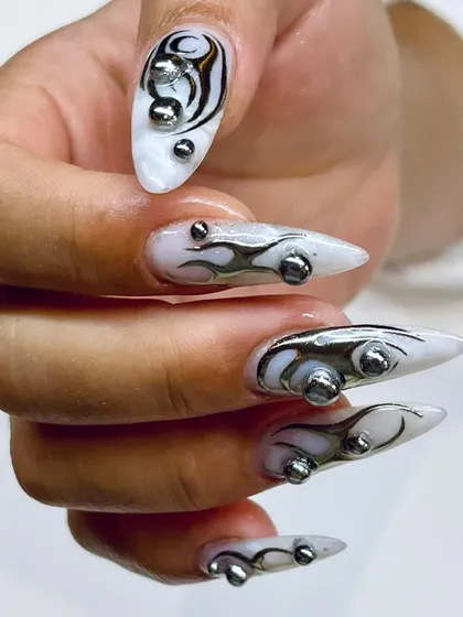 A close-up showcasing the intricate flame details and metallic orbs on this avant-garde nail set. This is high-fashion nail artistry at its finest.