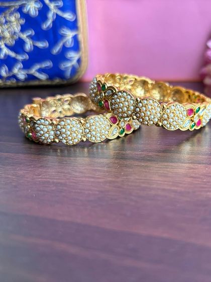 Another view of the pearl bangles, showing the fine detailing on the side.