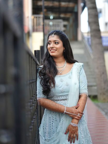 This bride looks effortlessly elegant. The soft waves in her hair and the dewy finish of her makeup create a look that is both modern and timeless.