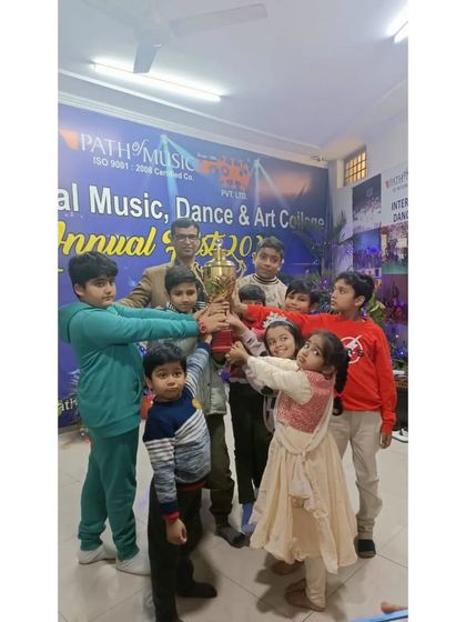 Our young champions holding the trophy at the Annual Fest. We encourage friendly competition and celebrate the achievements of all our students, building their confidence from a young age.