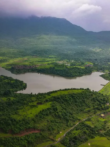 Are you missing Badlapur’s Monsoon? A beautiful aerial shot of the landscape around Kondeshwar, with the lake and the green hills under a cloudy sky.