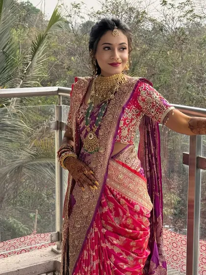 Another angle of the bride on the balcony, showing her beautiful saree and jewellery.