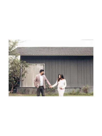 A wide shot of a couple holding hands in a modern outdoor setting. This image captures a sense of partnership and the beginning of a new chapter together.