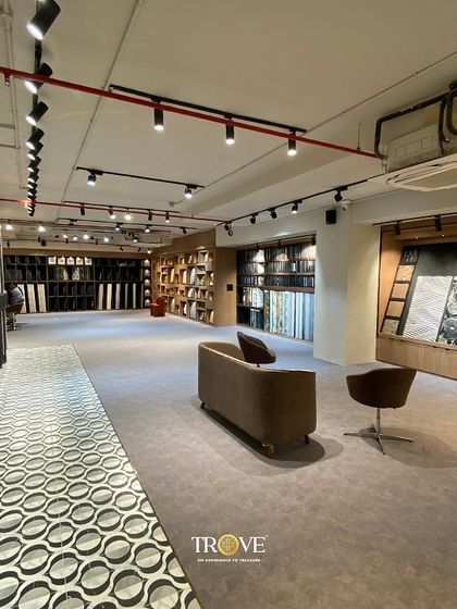 Our showroom features dedicated zones for different styles. This area showcases a variety of patterned floor tiles alongside our extensive collection of large format wall tiles, with a comfortable seating area for design discussions.