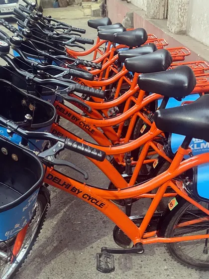 A close-up of our signature orange bikes, all ready for a 'Dilli Darshan'. The sturdy frames and comfortable seats are designed for city riding.