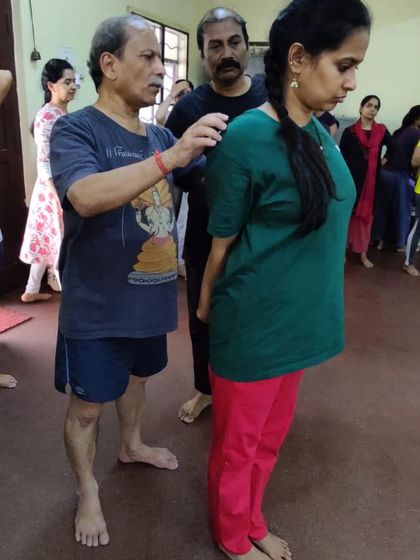 Giving a hands-on adjustment during a workshop. Creating a supportive and safe learning environment is my priority.