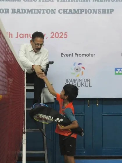 A moment of sportsmanship as a young player shakes hands with the umpire. We emphasize respect and fair play as core values in all the junior badminton tournaments we organize.