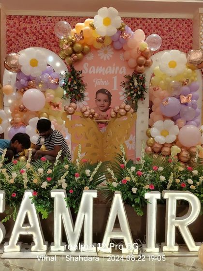 A behind-the-scenes look as my team puts the finishing touches on this elaborate flower and butterfly-themed stage for a first birthday.