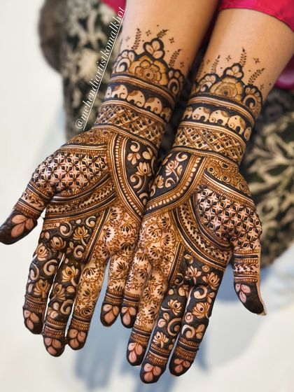An intricate and beautiful design for Karwachauth, featuring elephant motifs and geometric patterns.