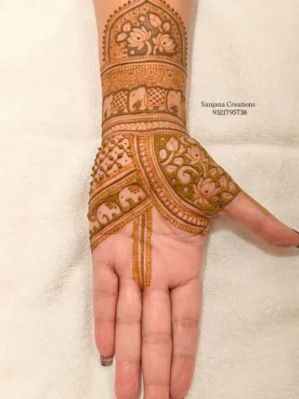 The back of the other hand, featuring delicate lotus and elephant patterns.