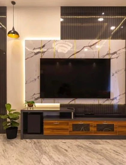 A TV unit can be a stunning focal point. In this living room, I combined the elegance of marble-finish panels with warm wood tones and integrated shelving, creating a modern and sophisticated entertainment center that is both beautiful and practical.