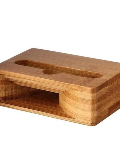 A side view of our bamboo mobile stand and passive sound amplifier. This image showcases the simple yet clever design that holds your phone securely while naturally boosting its volume, all made from a single piece of sustainable bamboo.