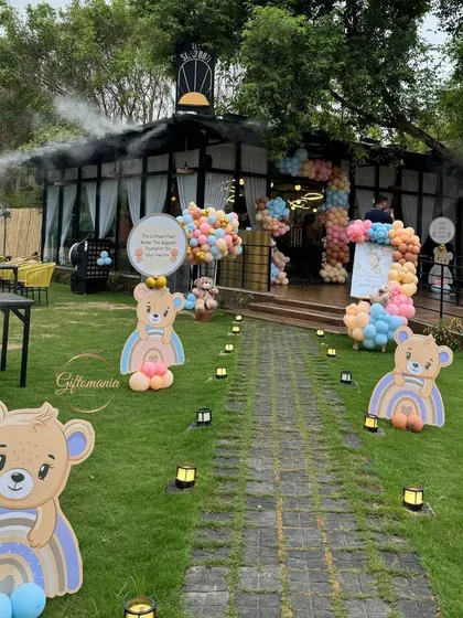 A whimsical outdoor entrance for a pastel rainbow teddy bear shower. The walkway is lined with adorable bear cutouts, guiding guests to a colorful and fun-filled celebration.