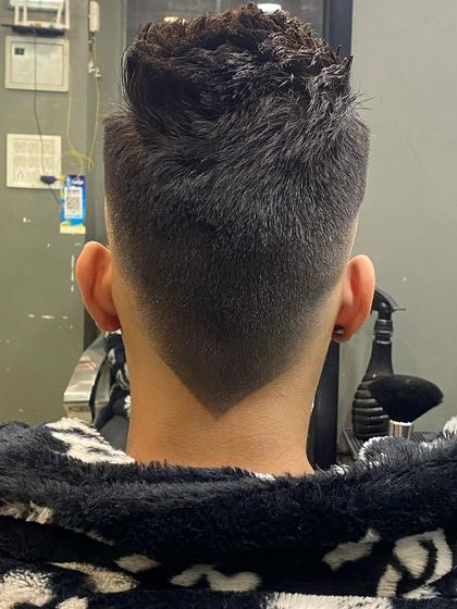 The back view of a perfect V-shaped taper fade. The symmetry and sharpness of the V is a detail I take great pride in.