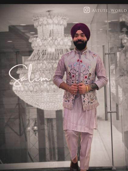 A client wearing a pastel lavender kurta set with a matching floral embroidered Nehru jacket. This is a perfect look for a spring wedding or a daytime event.