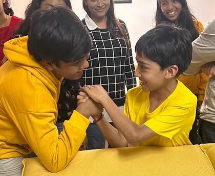 A friendly arm-wrestling match during a team dinner. It's these moments of fun and laughter that build our team spirit.