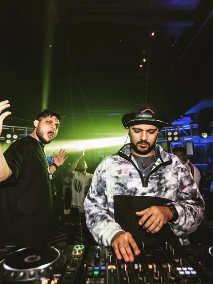 Another dynamic shot of me and a fellow DJ working together to hype up the crowd.