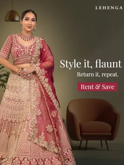 A model showcases a heavily embellished beige and red lehenga, a perfect choice for a bride seeking a traditional yet opulent look for her wedding day.