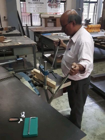 An instructor demonstrates the setup and operation of a mortising machine, a critical skill for anyone serious about solid wood furniture construction.