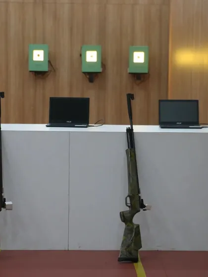 A view of our air rifle stations, featuring electronic targets and laptops for scoring. We provide top quality equipment to ensure our shooters have the best tools to hone their skills.