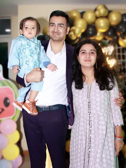 A classic family photo at a Cocomelon-themed first birthday party. I cover parties with all kinds of popular cartoon themes for kids.