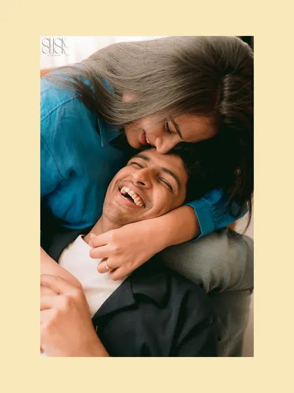A playful and loving moment captured from above, showing a different perspective on a cozy studio cuddle.